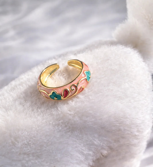 Enamel petal drift ring with pink band, green and blue floral accents, gold-tone edge