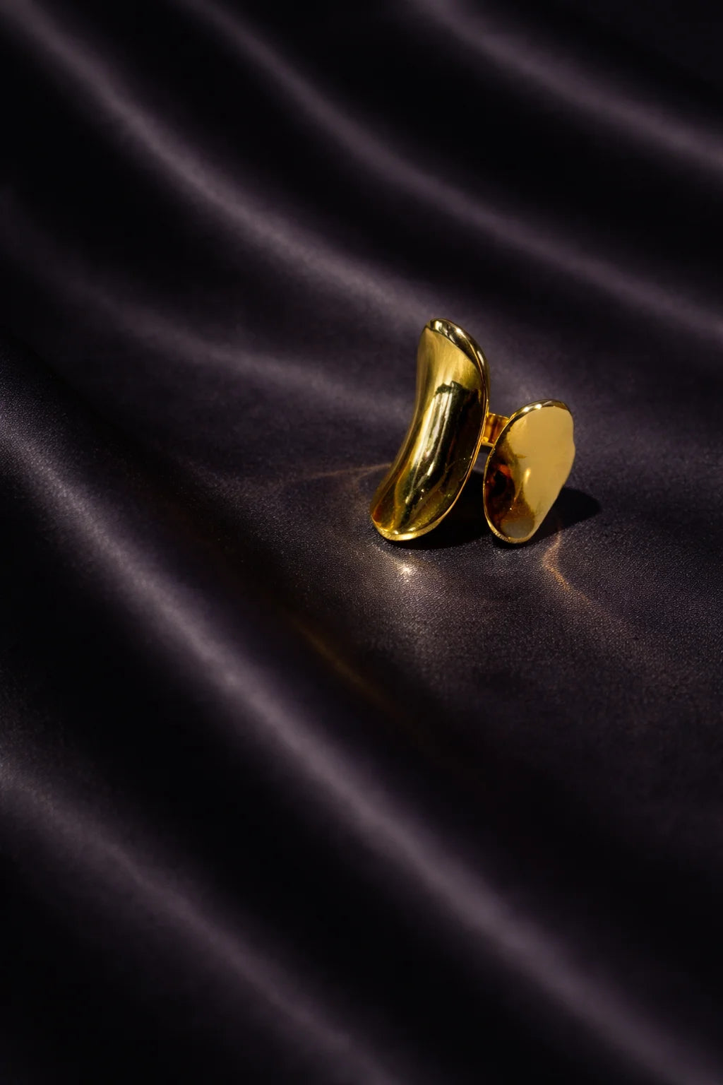 Gold abstract art ring with curved oval open-back design