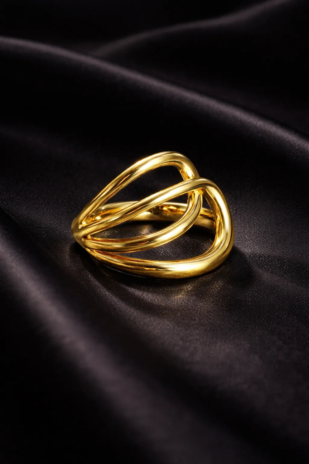Gold-tone double-layer ring with two interlocking oval loops, high shine finish