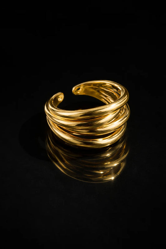 Four-layer gold ring with stacked spiral bands, glossy finish