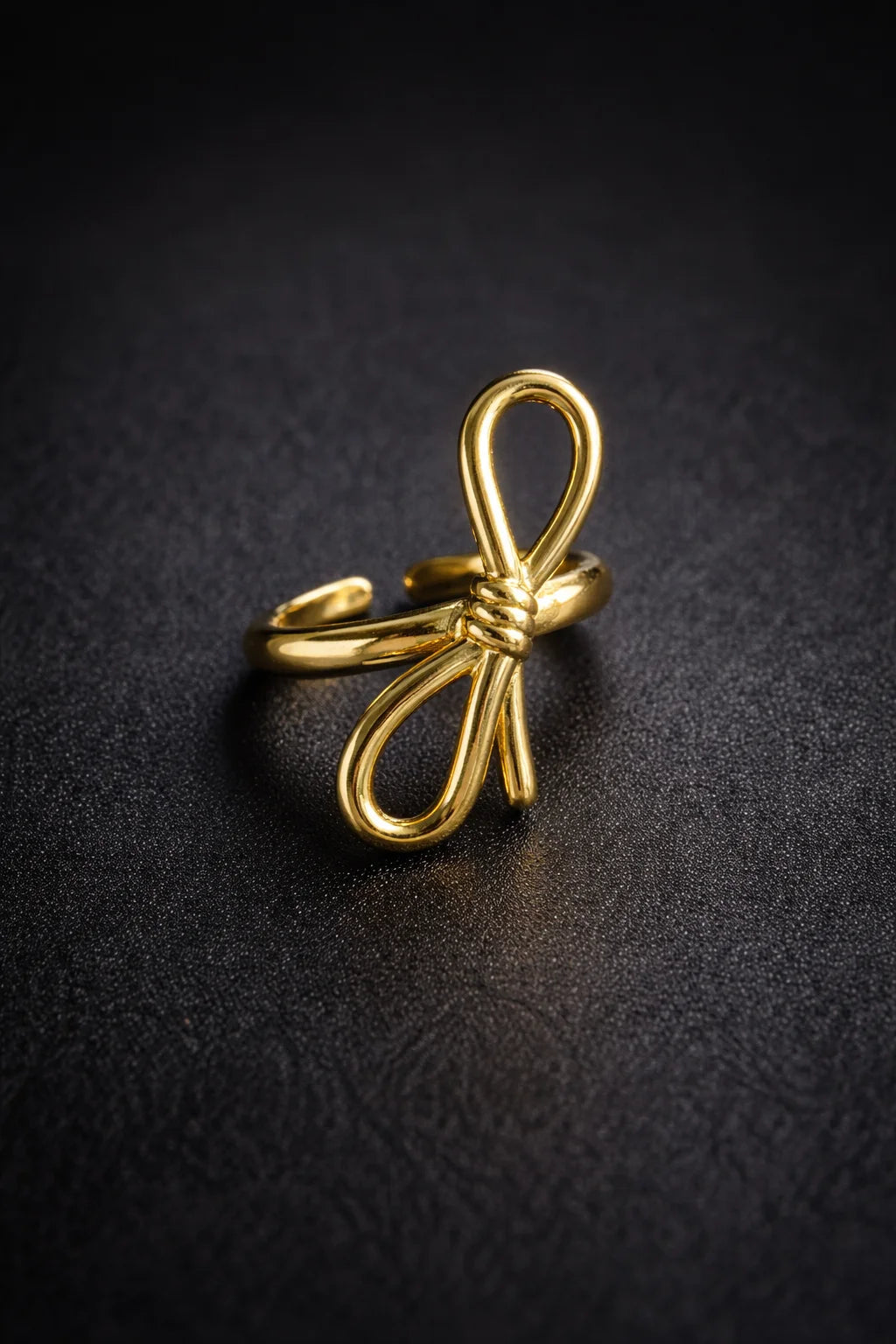 Gold-tone rope knot ring with looped band, polished finish