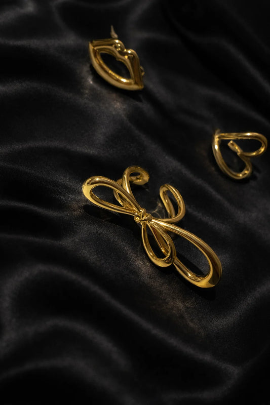 Gold-tone knot ring with interlinked loop design