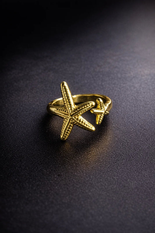Gold-tone starfish ring with openwork starfish design on a slim band.
