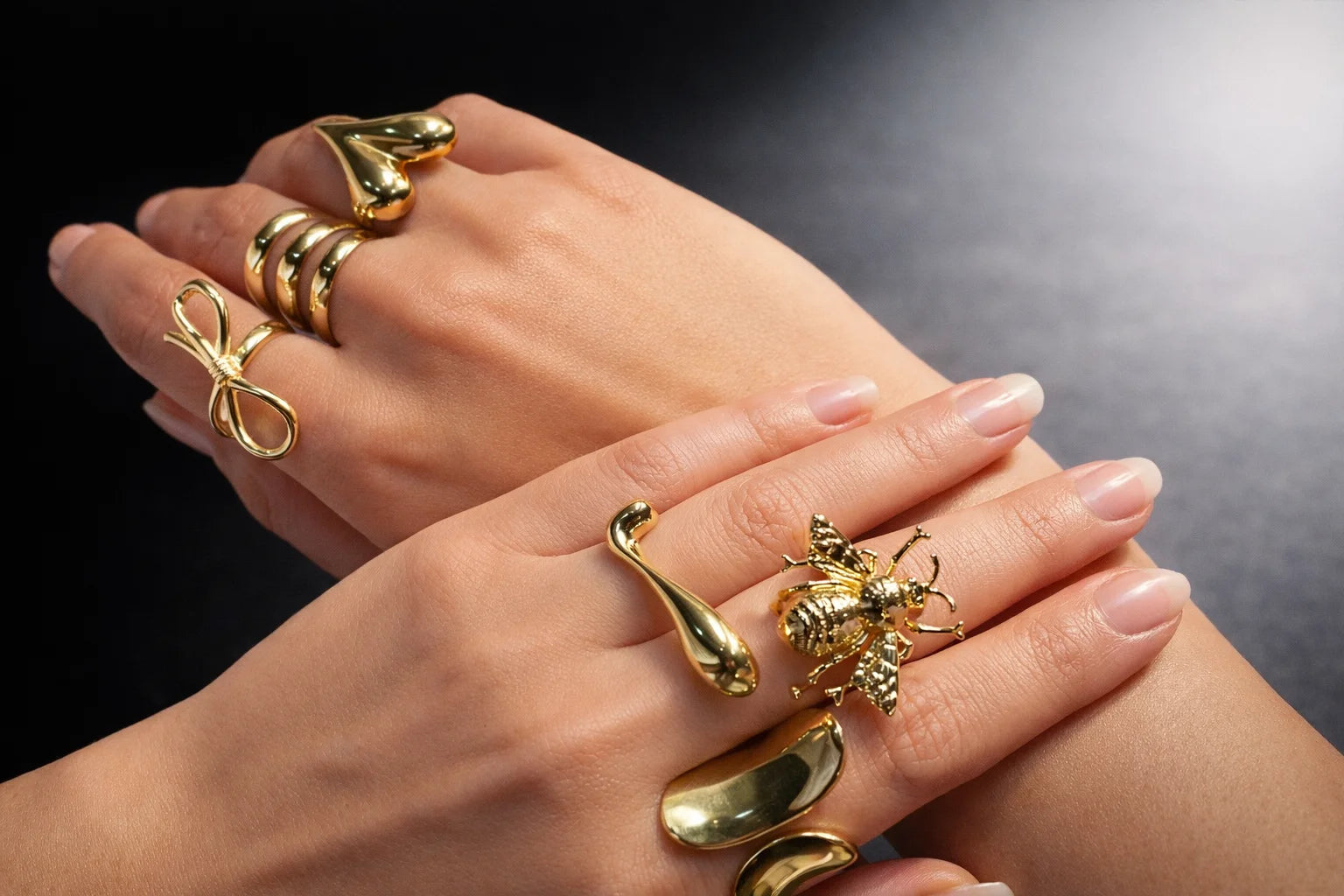 Gold three-layer ring with stacked curved bands on hand, polished shine