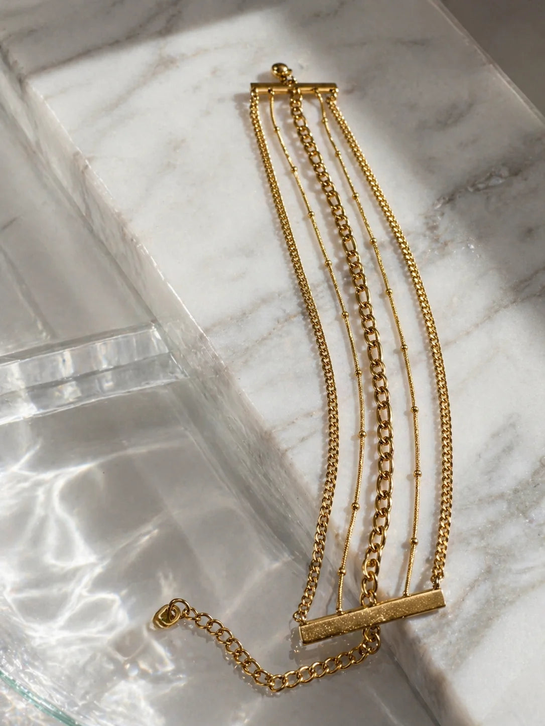 Layered 18K gold-plated chain bracelets with bar detail and lobster clasp