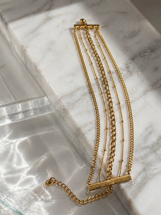 Layered 18K gold-plated chain bracelets with bar detail and lobster clasp