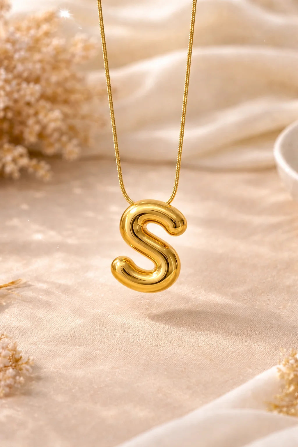 Letter S pendant necklace with gold-tone chain and curved S charm