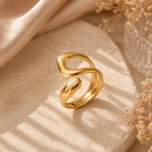 Gold tone sculptural open ring with connected loop design