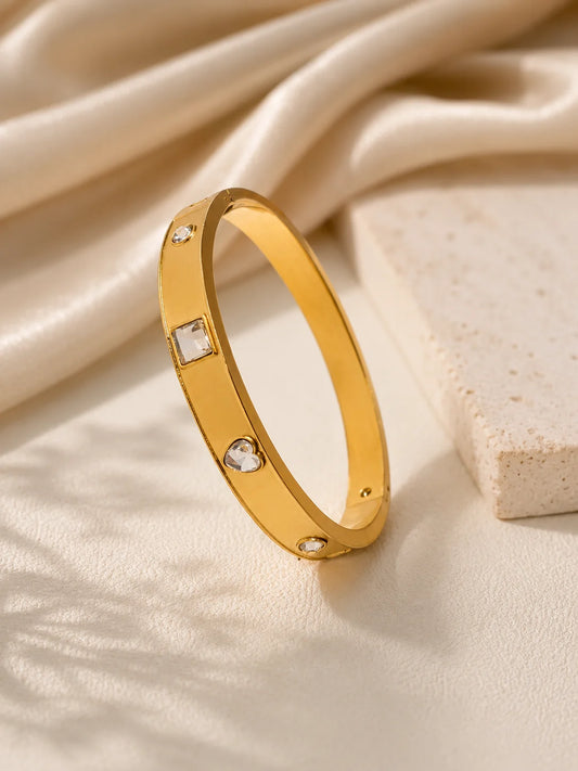 Gold-tone kada bangle with square and round rhinestone accents, side view
