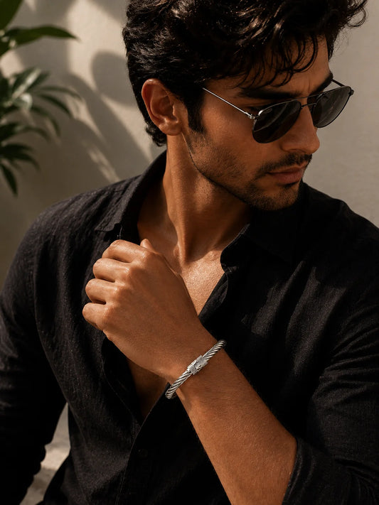 Braided stainless steel crown kada bracelet on wrist with small crown charm
