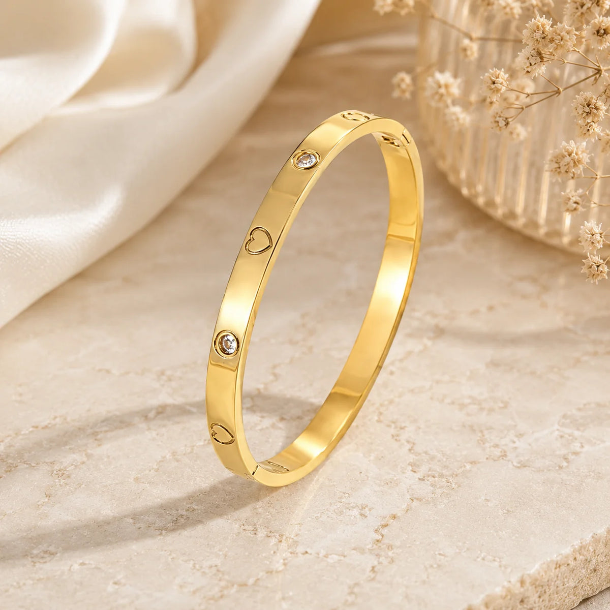 Gold-tone stainless steel kada bracelet with heart links and crystal stones