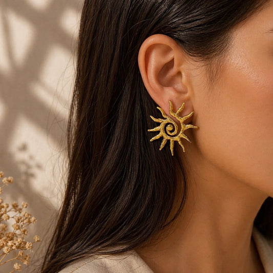 Gold sunburst stud earrings with a circular center and radiating rays