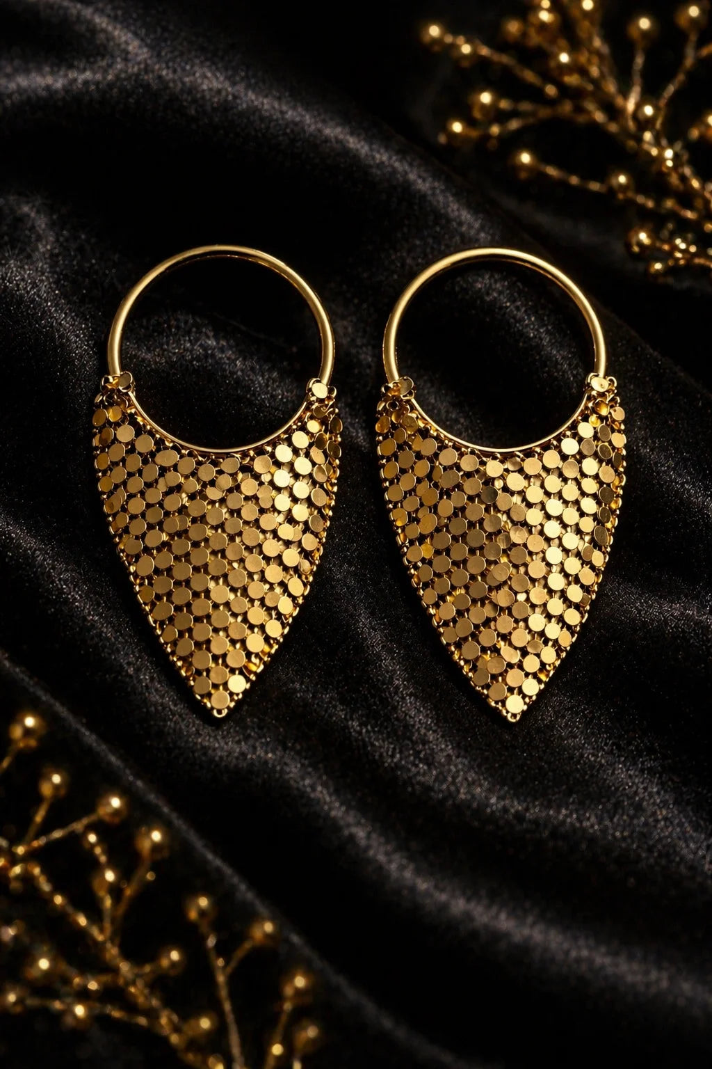 Pair of gold triangular drape hoop earrings with coin-like sequin tassel