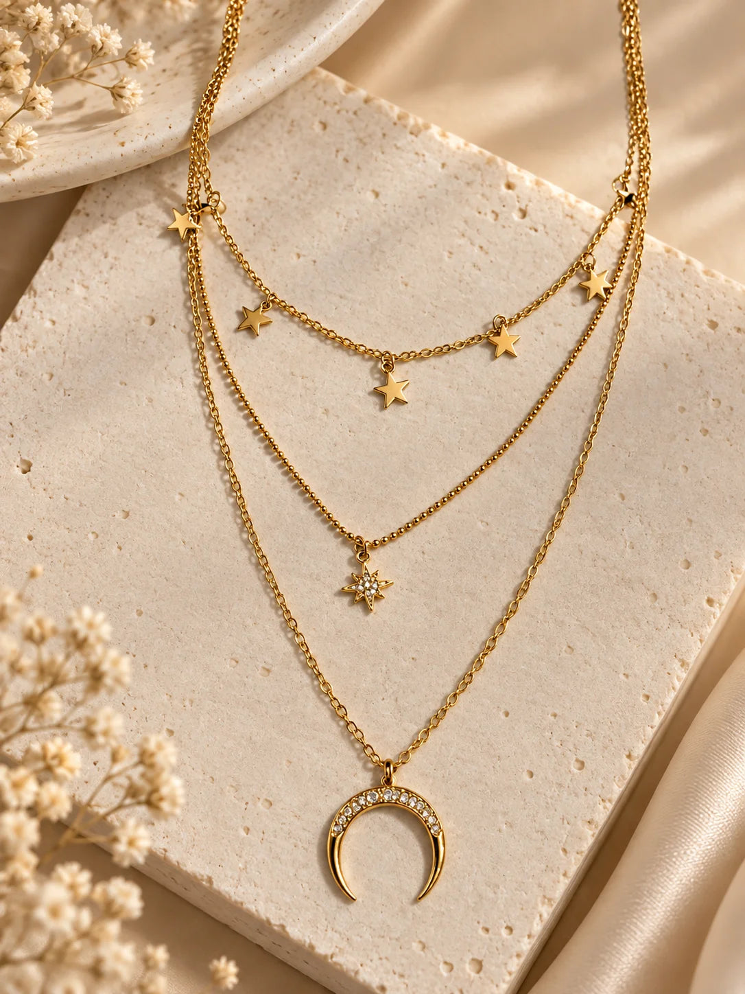 Gold triple-layer necklace with crescent moon pendant and star charm links