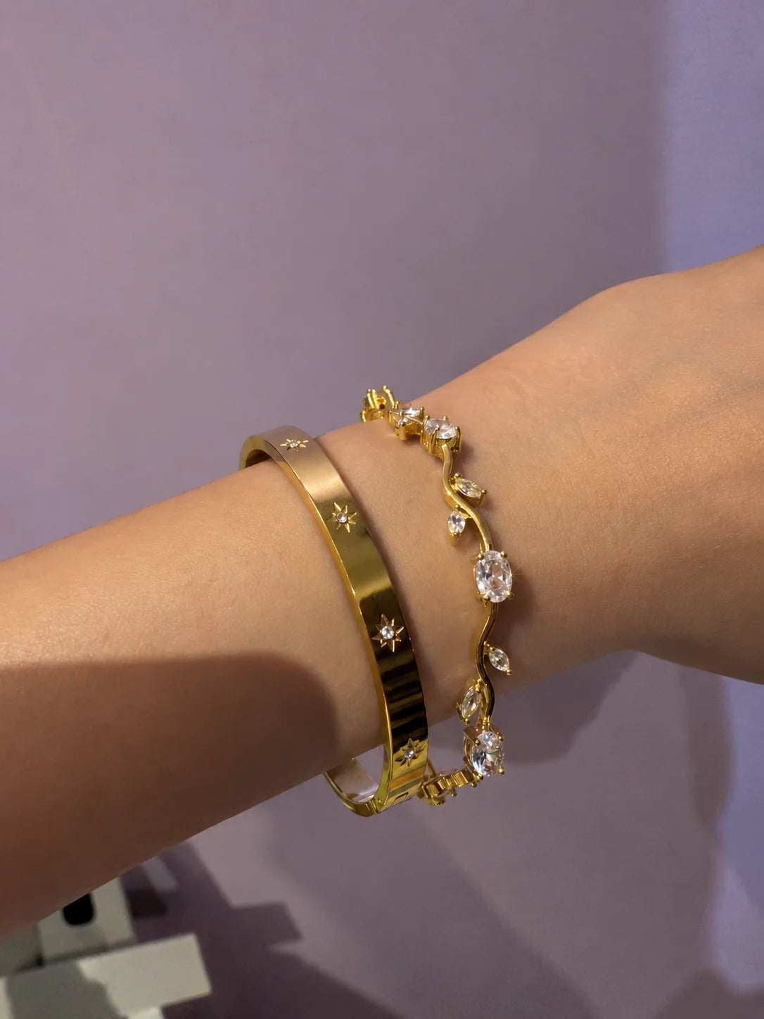 Gold-tone bracelet with clear rhinestone links and tulip-style center detail