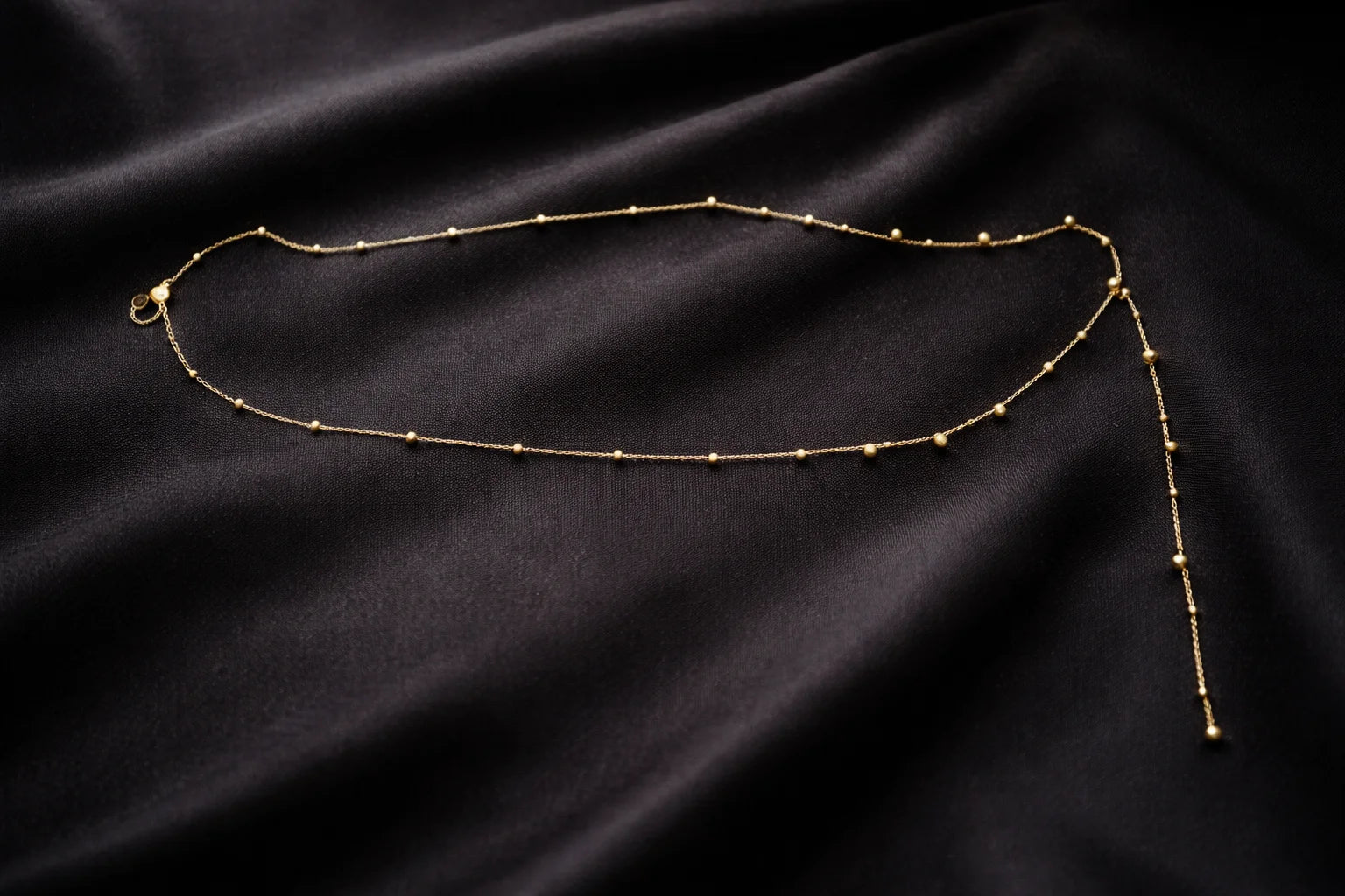 Gold beaded waist chain with clasp and long tassel end