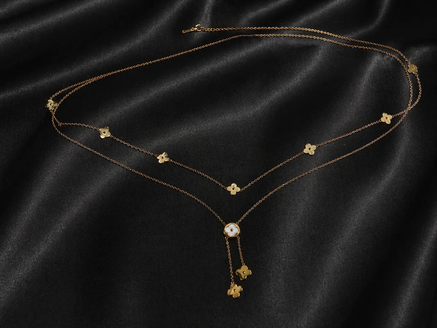 Gold clover waist chain with small clover charms and dangling round center