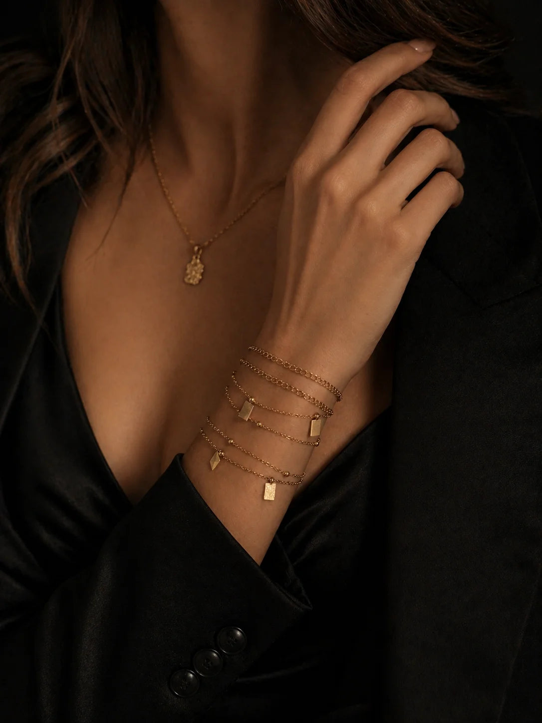 18K gold-plated multi-wear chain with bar charms, draped across neckline and chest