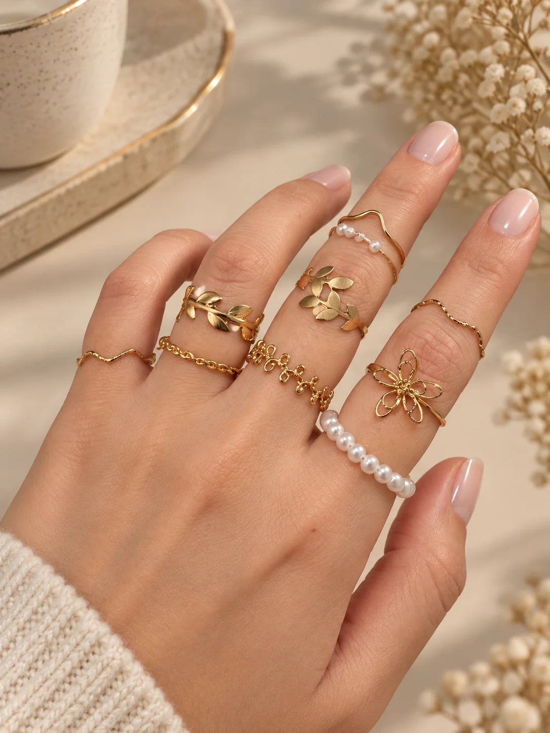 Gold-tone adjustable ring set with pearls and flower, leaf, bow details