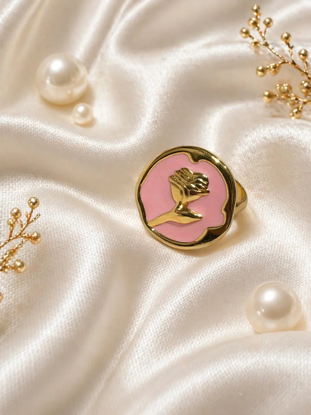 Gold-tone ring with rose-pink enamel cameo and bird silhouette